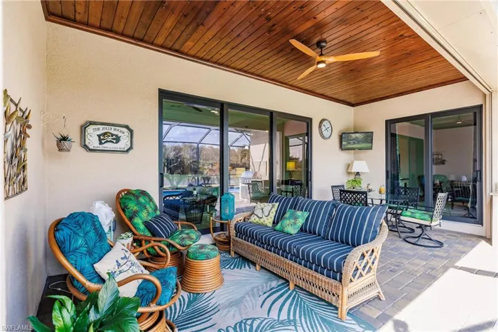 View of beautiful patio with ceiling fan and wood ceiling
