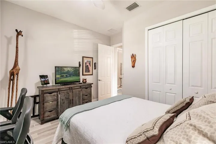 Bedroom featuring tile flooring and a closet