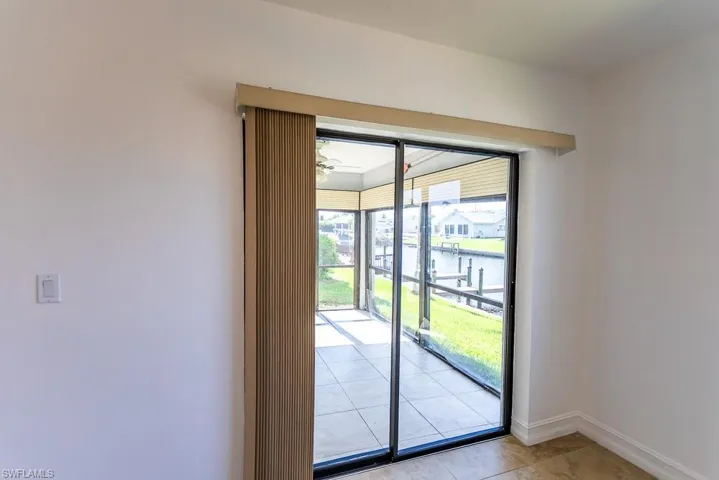 Entryway with light tile patterned floors and a water view