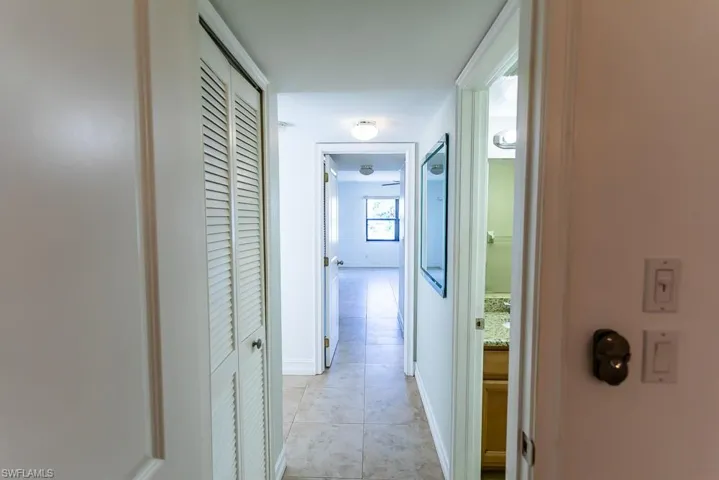 Corridor featuring light tile patterned floors