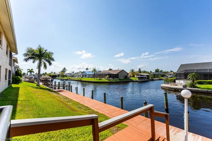 View of dock featuring a water view and a yard