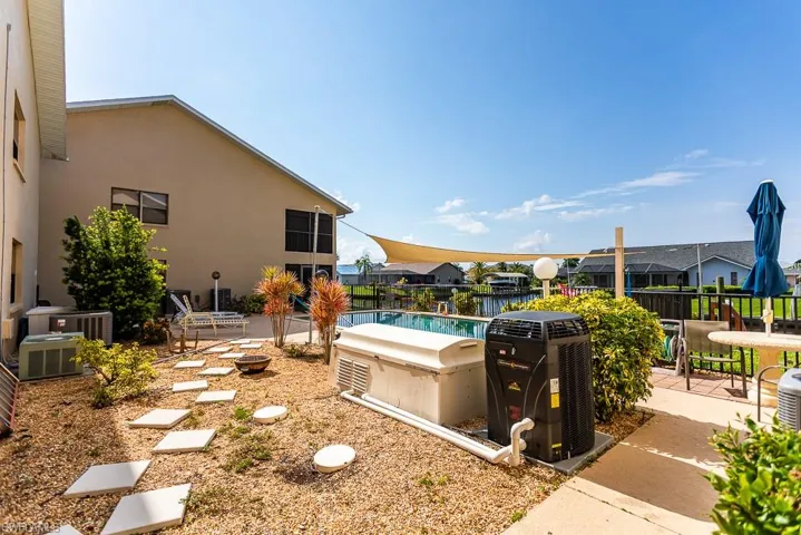 View of yard with central AC unit, a patio, and a fenced in pool