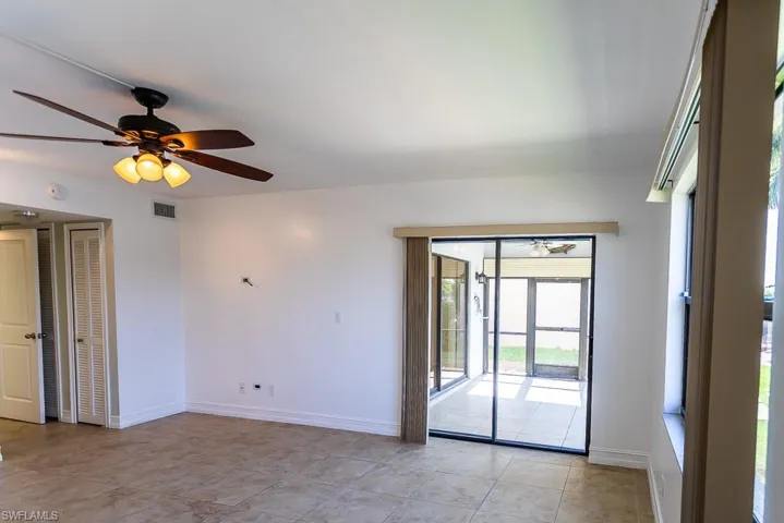 Empty room featuring ceiling fan and light tile patterned flooring