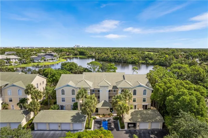 Birds eye view of property with a water view
