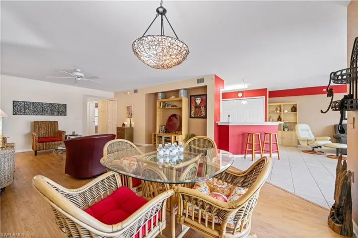 Dining space with built in features, light hardwood / wood-style flooring, and ceiling fan