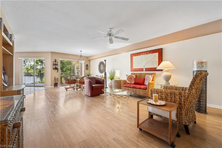 Living room  and dining room flow seamlessly together featuring light wood-type flooring, ceiling fan.