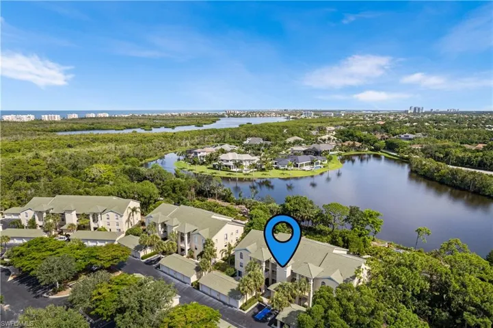 Birds eye view of property with a water view.