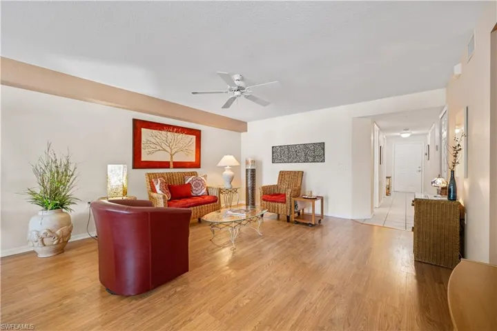 Living room featuring ceiling fan and hardwood / wood-style flooring