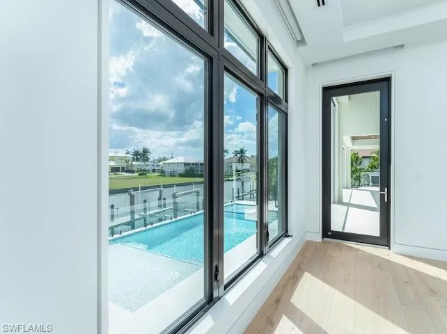 Doorway to outside featuring wood finished floors and a water view