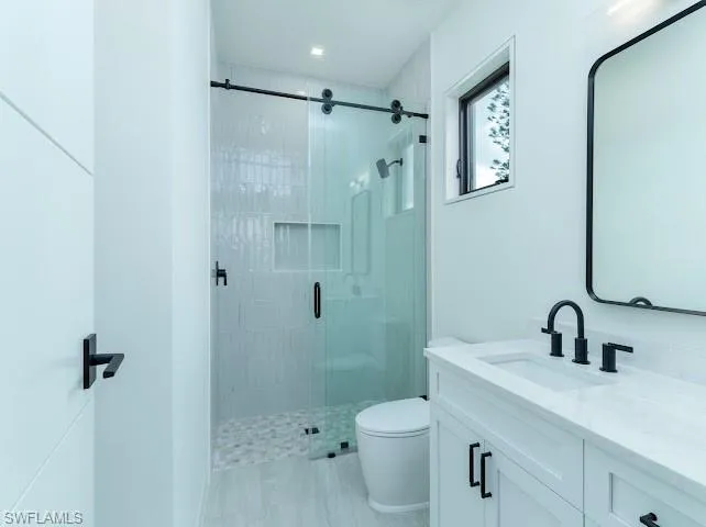 Full bath featuring vanity and a stall shower