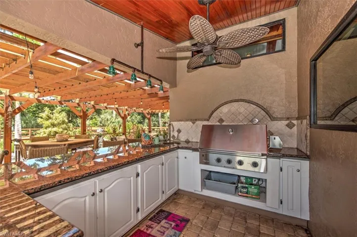 View of patio with a pergola, area for grilling, ceiling fan, and a grill