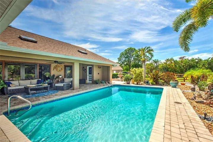 View of swimming pool featuring outdoor lounge area, ceiling fan, and a patio area
