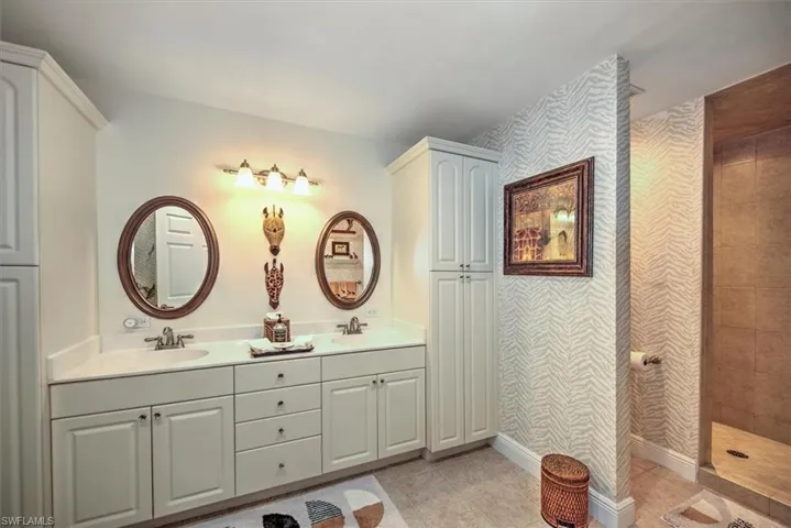 Bathroom featuring double vanity and tile patterned flooring