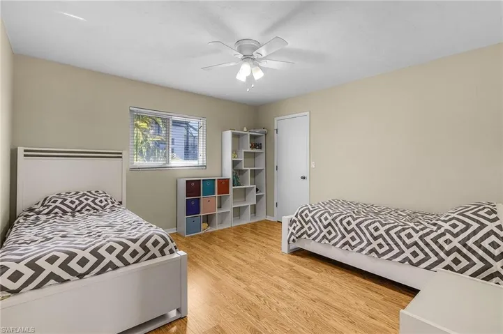 Bedroom with ceiling fan and light hardwood / wood-style floors
