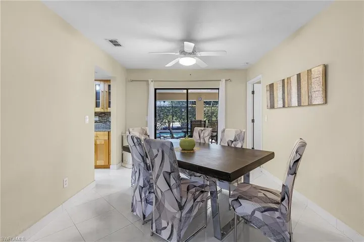 Tiled dining space with ceiling fan
