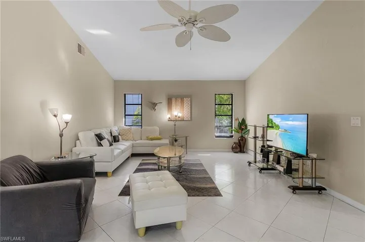 Tiled living room featuring ceiling fan