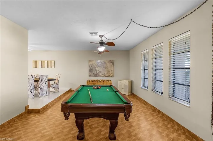 Recreation room with ceiling fan and billiards