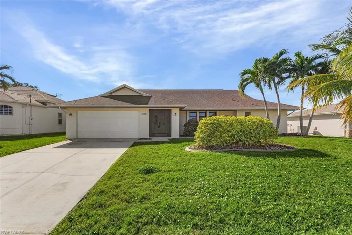 Ranch-style house with a front lawn and a garage