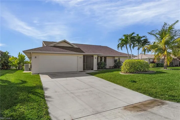 Ranch-style house with a garage, central AC unit, and a front yard