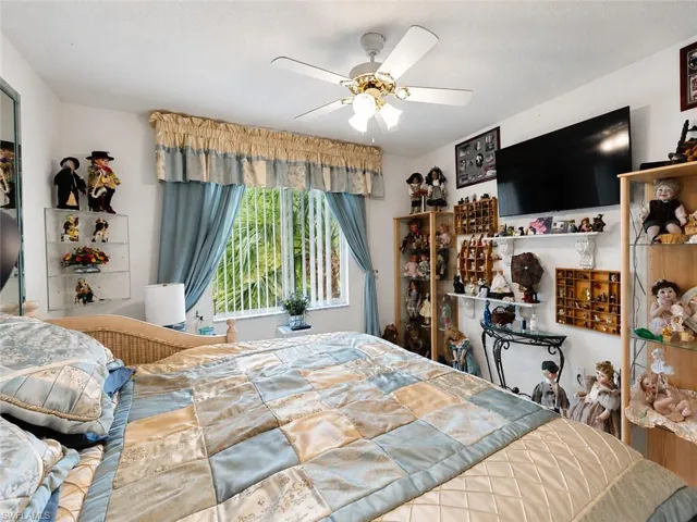 Spacious room featuring a ceiling fan with integrated lighting, window with vertical blinds, and ample wall space