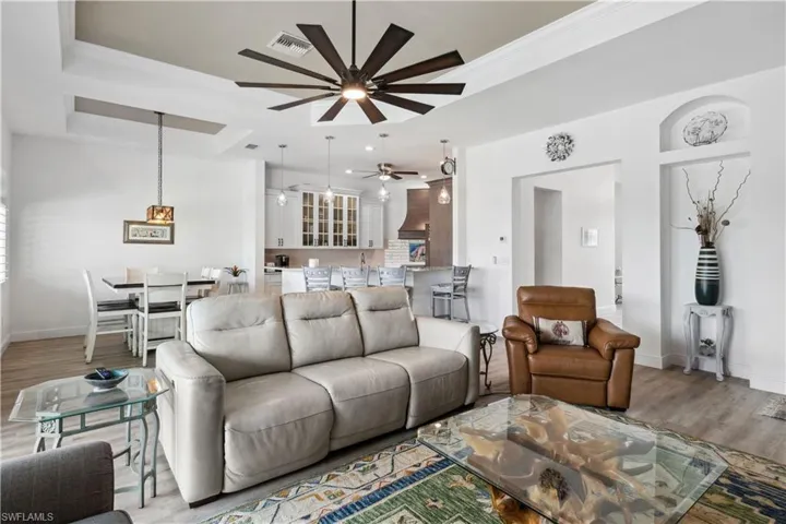 The living area is open and inviting, seamlessly flowing into the kitchen and dining spaces to create a spacious, connected layout perfect for everyday living and entertaining.