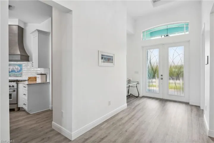 The foyer is an elegant and inviting space, defined by double doors that open to reveal a grand entrance.