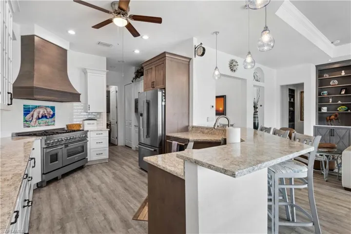 The kitchen is equipped with top-of-the-line stainless steel appliances, including a professional-grade gas range, a double oven, and a built-in refrigerator, ensuring every cooking need is met.