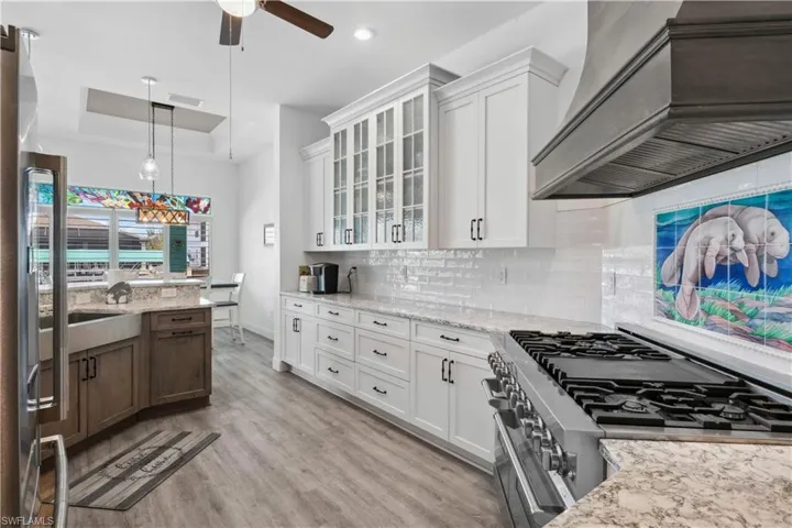 A modern range hood above the stove adds a bold visual element while efficiently ventilating the space.