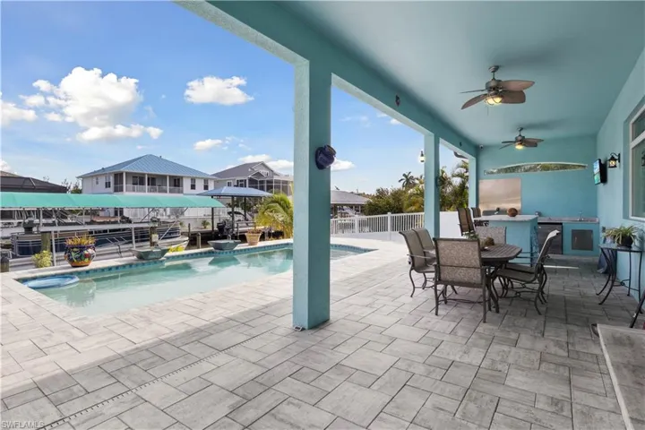 The pool and lanai area offer a relaxing outdoor retreat with a sparkling pool, spacious deck, and covered seating area—perfect for enjoying the Florida sunshine or entertaining guests.
