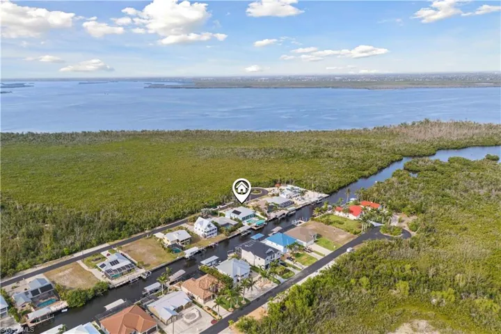 An aerial view of the property reveals a prime location with direct canal access to the Gulf, offering a seamless transition from your backyard to open waters.