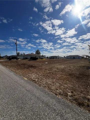 View of asphalt road featuring a residential view