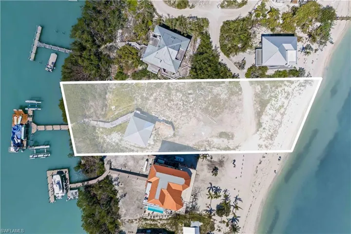 Small guest home remains  and is sold as-is.  This is a rare property offering Bay to Gulf access with deep waters and multiple boat lifts!