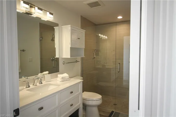 Bathroom with vanity and a stall shower