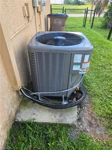 Exterior view of a new cooling unit and stucco siding