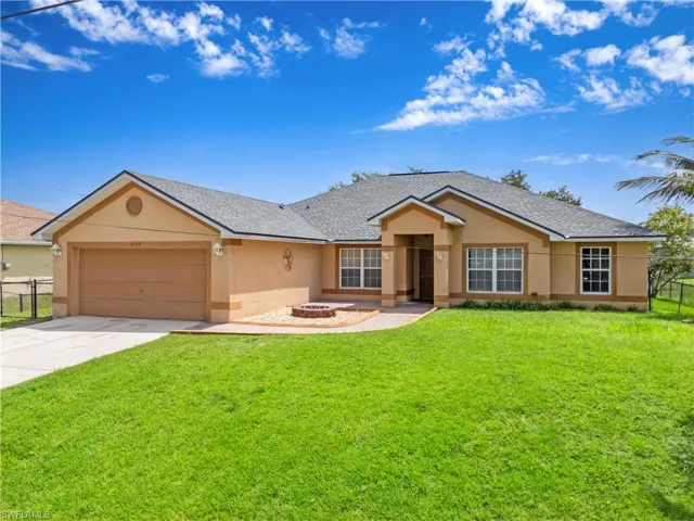 Single story home featuring stucco siding, roof with shingles, concrete driveway, and a garage