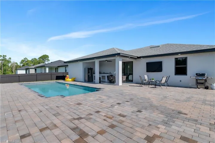 View of pool with a patio area and ceiling fan