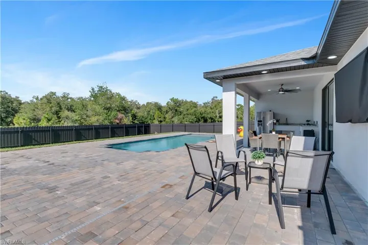 View of swimming pool featuring a patio and ceiling fan