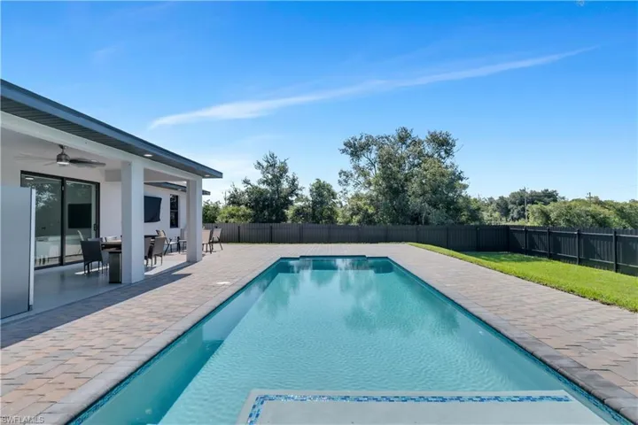View of swimming pool featuring a patio and ceiling fan