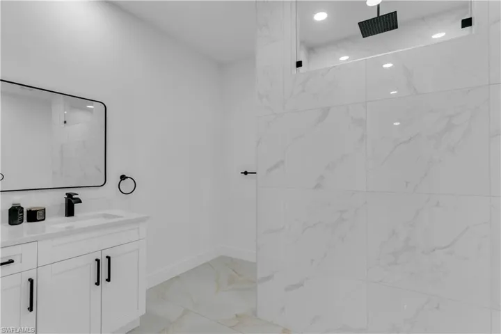 Bathroom with tile patterned flooring and vanity