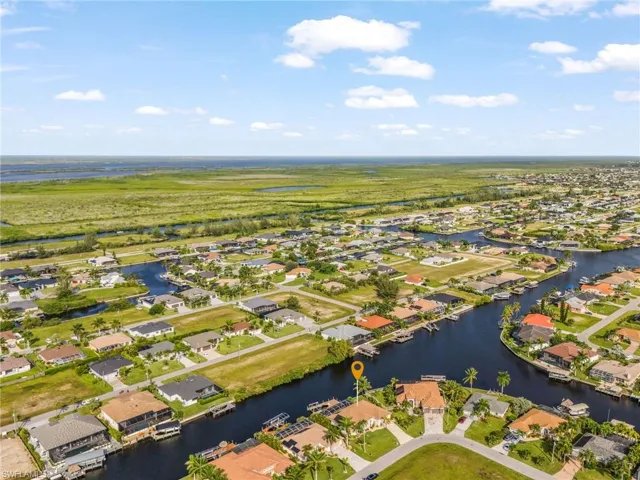 Waterfront property featuring a private boat dock and a circular driveway