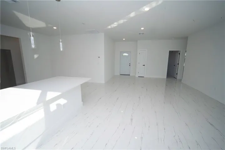 Unfurnished room featuring recessed lighting and baseboards