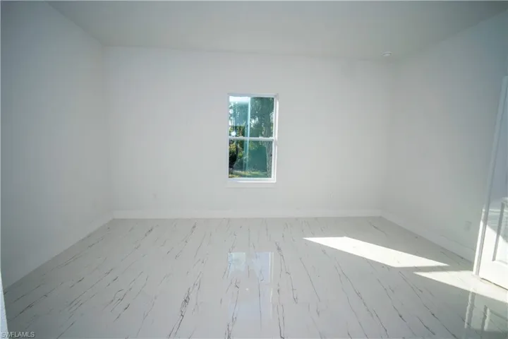 Spare room featuring baseboards