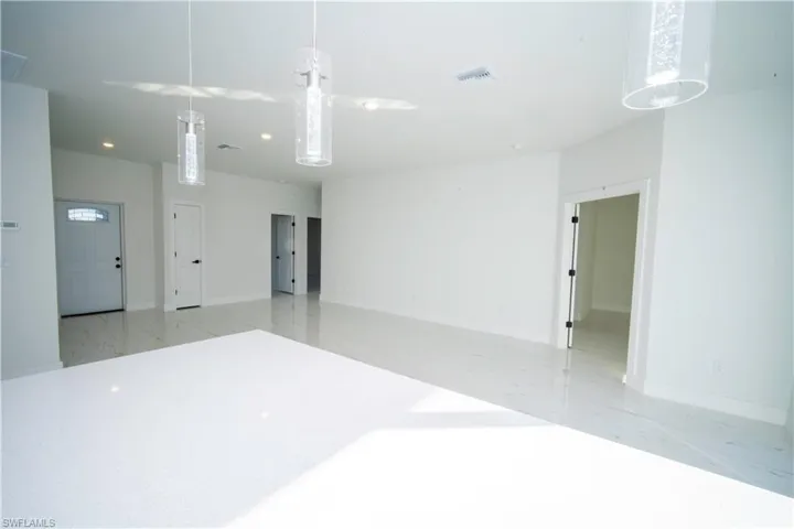 Unfurnished room featuring recessed lighting and light marble finish flooring