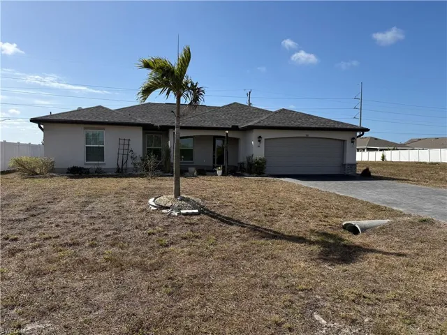 Ranch-style house with stucco siding, driveway, a garage, and roof with shingles
