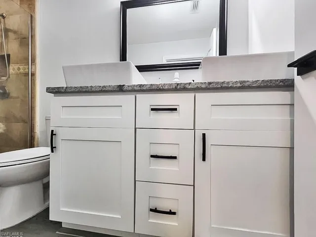 Bathroom with a stall shower and vanity