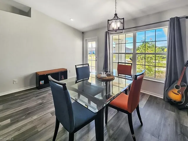 Dining room featuring dark wood-type flooring and suspended lighting
