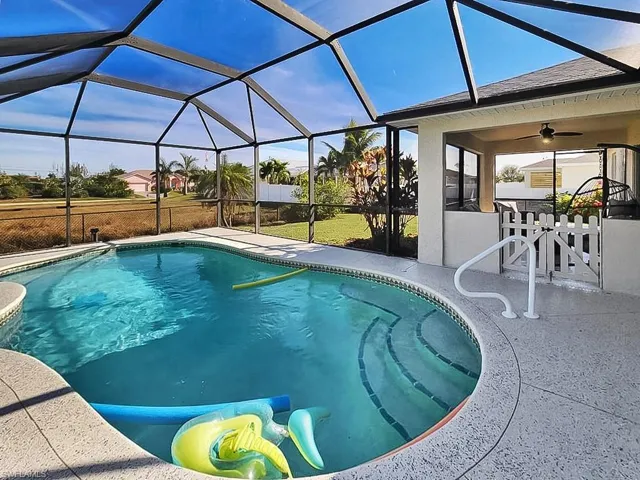 Outdoor pool featuring a lanai, a sunroom, outdoor dining space, and a patio