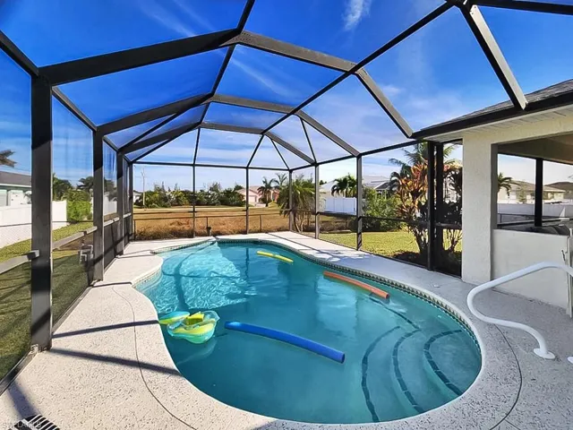 Outdoor pool with glass enclosure and a sunroom