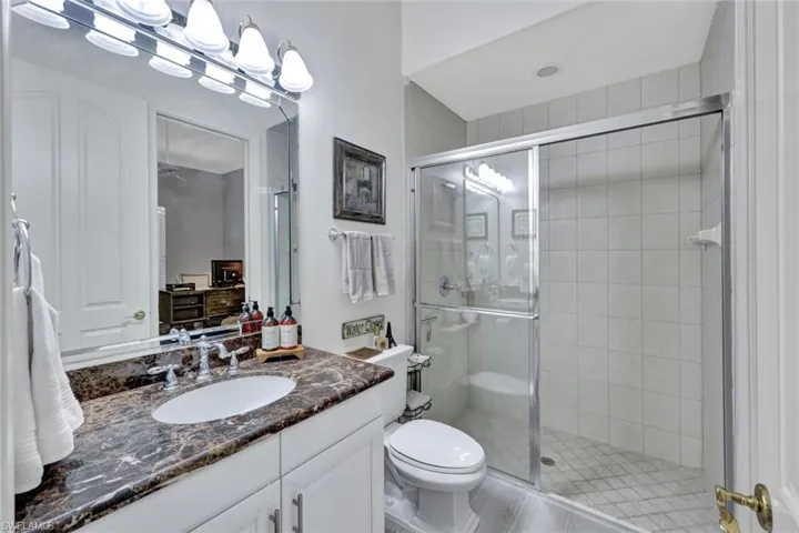 Guest bathroom with vanity and a stall shower