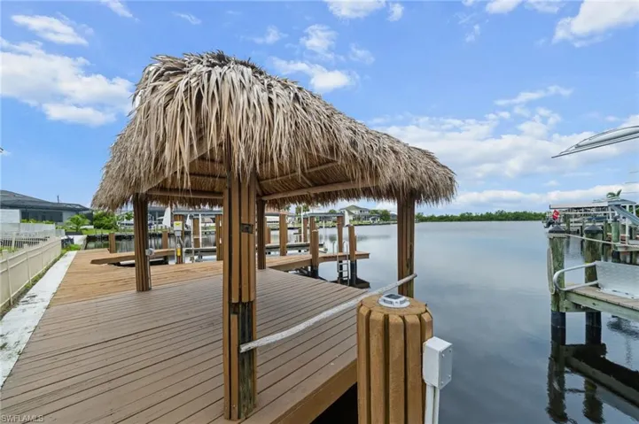Dock area featuring a water view and boat lift
